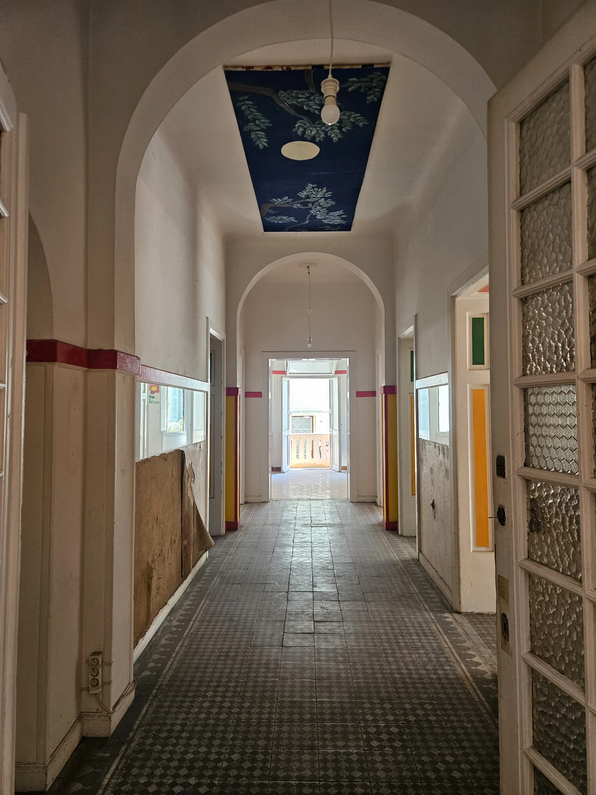 First floor, current condition — arched corridor and patterned flooring
