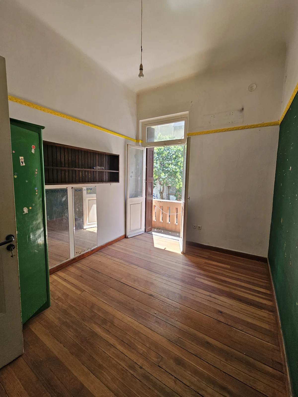 First floor, current condition — room with mirrored storage and balcony access