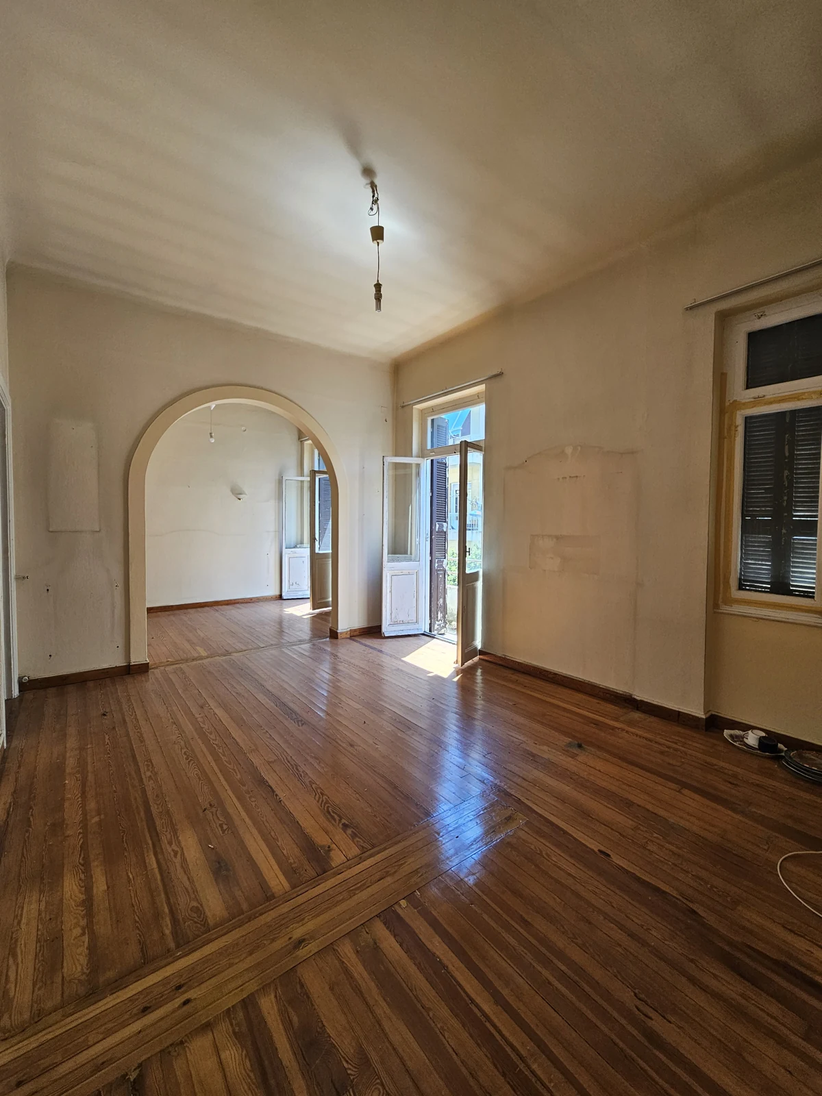 Second floor, current condition — adjoining rooms with timber floors