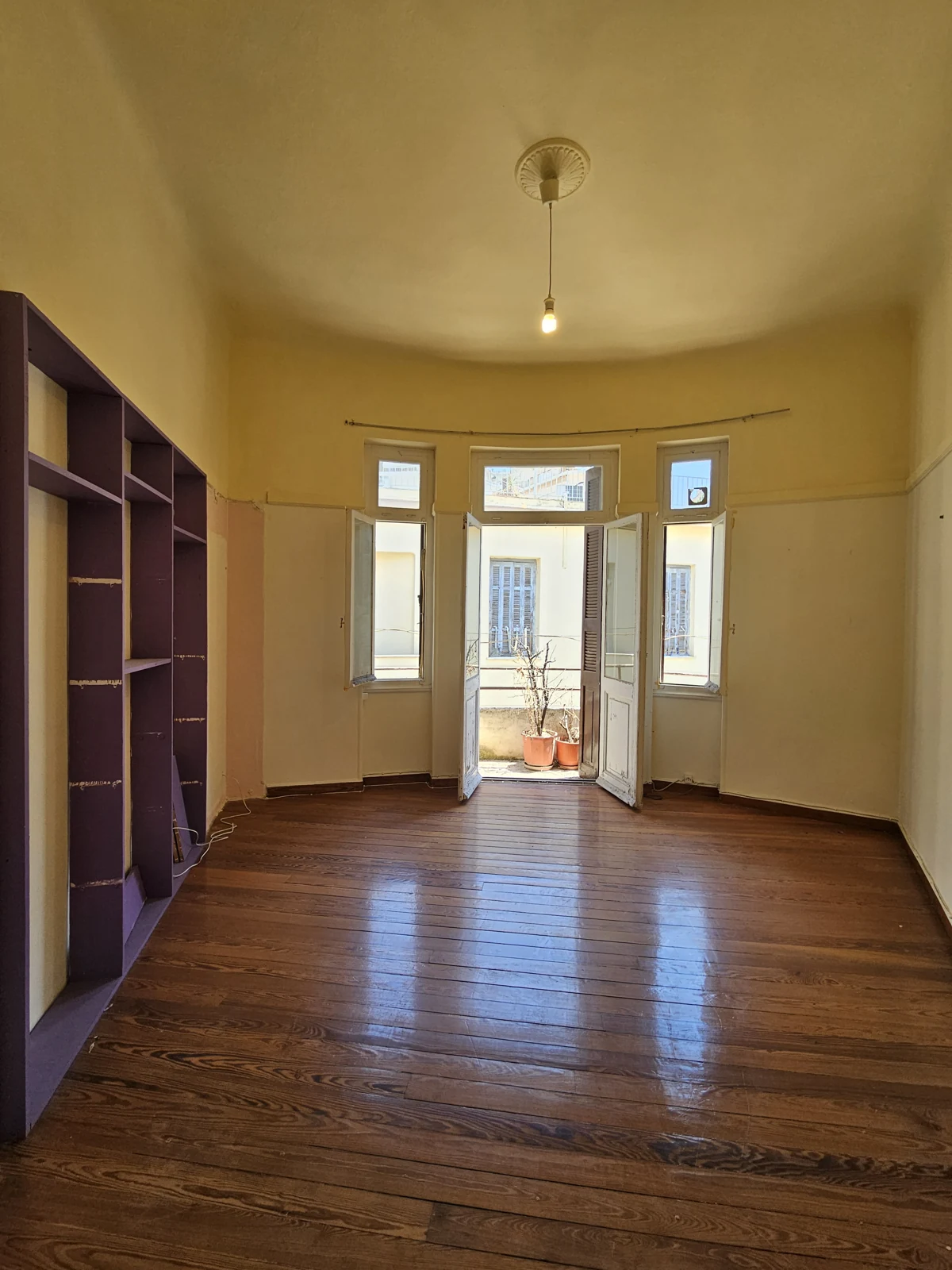Second floor, current condition — yellow room with balcony access