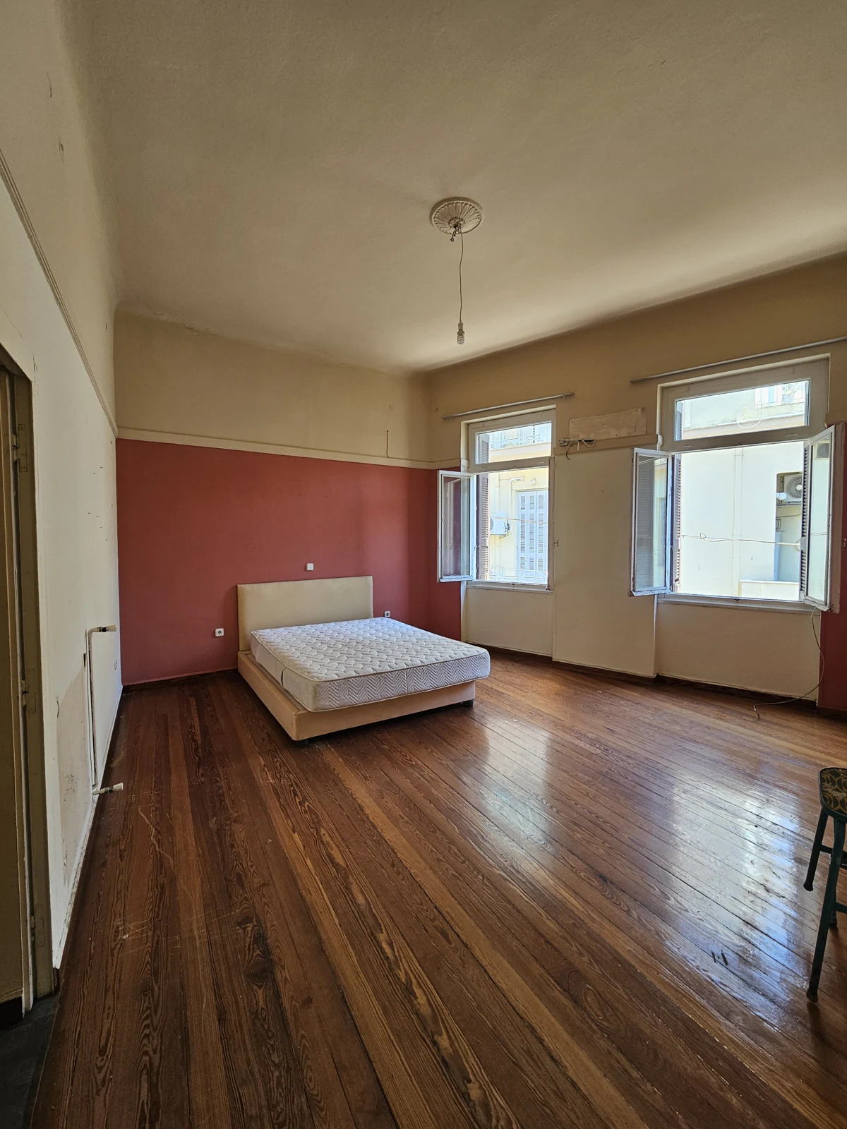 Second floor, current condition — room with red feature wall