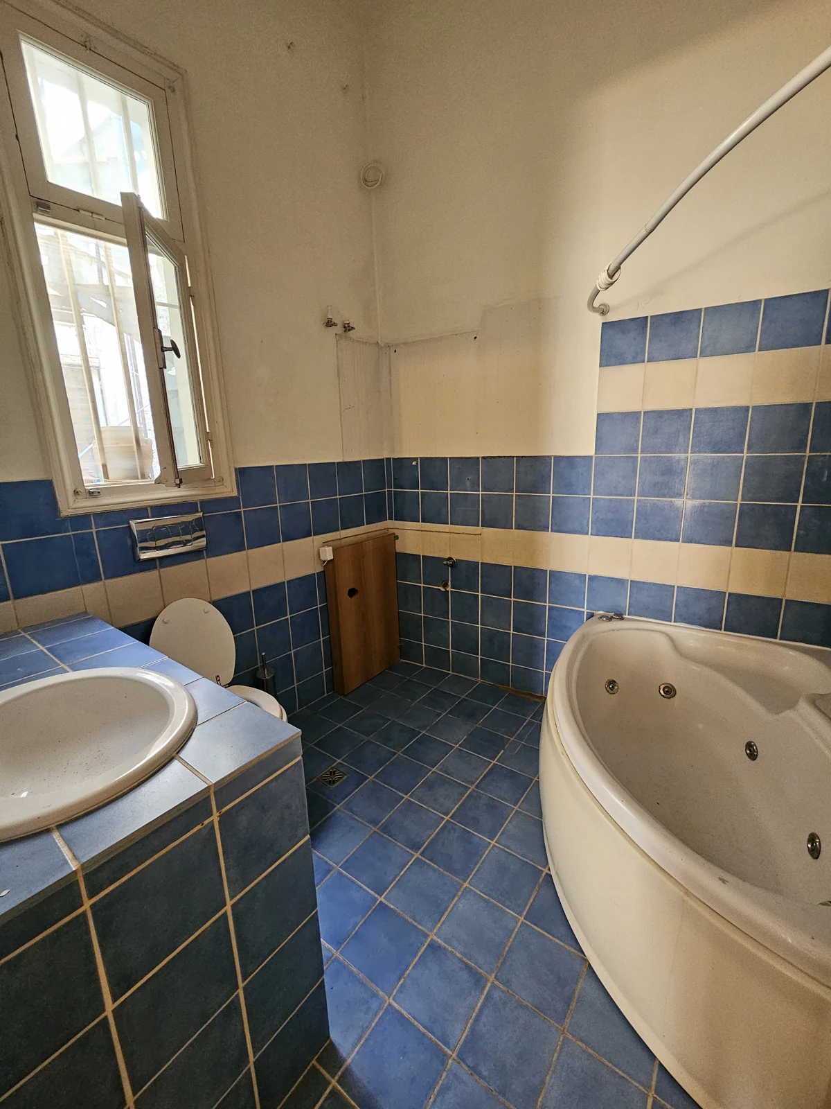 Second floor, current condition — existing blue-tiled bathroom